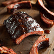 Load image into Gallery viewer, Smokey BBQ Pork Ribs - Heat & Eat | Auckland Grocery Delivery Get Smokey BBQ Pork Ribs - Heat & Eat delivered to your doorstep by your local Auckland grocery delivery. Shop Paddock To Pantry. Convenient online food shopping in NZ | Grocery Delivery Auckland | Grocery Delivery Nationwide | Fruit Baskets NZ | Online Food Shopping NZ These Smokey BBQ Ribs will be ready in under 15mins in the oven or 8mins in the microwave! Get all your grocery needs from Paddock to Pantry