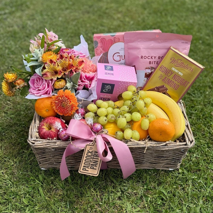 Blushing Bliss Gift Basket | Auckland Grocery Delivery Get Blushing Bliss Gift Basket delivered to your doorstep by your local Auckland grocery delivery. Shop Paddock To Pantry. Convenient online food shopping in NZ | Grocery Delivery Auckland | Grocery Delivery Nationwide | Fruit Baskets NZ | Online Food Shopping NZ Elegant gift basket with fresh fruit, chocolate, treats, and flowers. Perfect food hamper or care package, delivered nationwide.